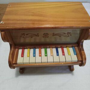 Small vintage wooden piano with percussion mallets